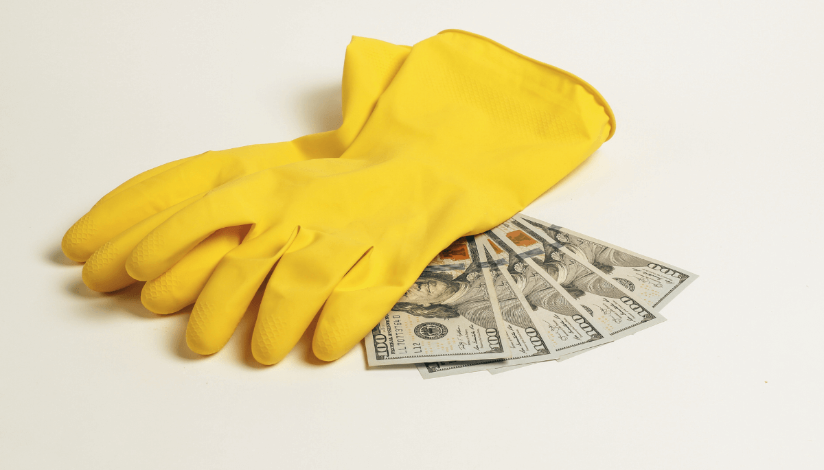 Yellow rubber gloves laying on money