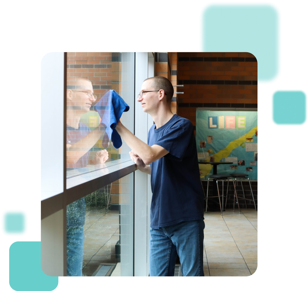 Man wiping windows with a blue cloth